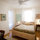 Guest room with queen bed and desk.