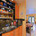 Kitchen looking out to living room and large city backyard