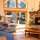 plenty of seating in spacious living room with lofted ceilings and doors to back yard