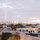 View of rooftops and lower Manhattan in the background. 