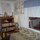 This is the library area alongside of one of two futons that can serve as spare beds in the common rooms