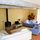 Lounge with exposed beams and wood burner