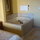 Large tub is located in bedroom area. Bathroom with shower is separated by door.