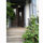 Front door in Bloom! Wisteria to the left, Autumn Clemetis and Pokeweed to the right. 