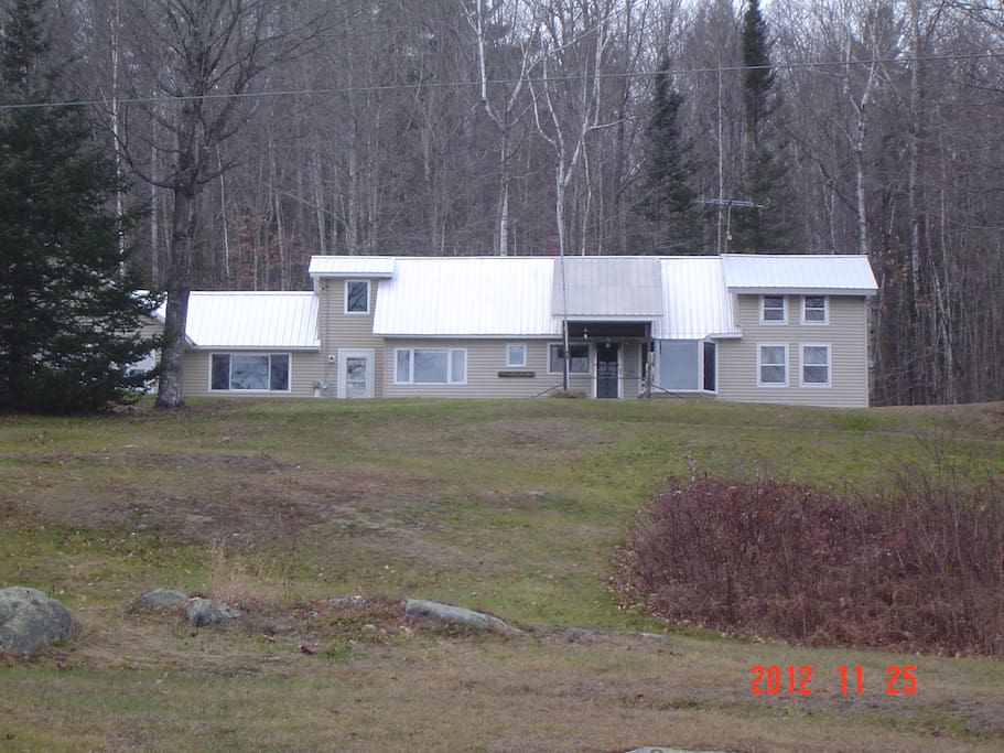 The Knoll before the snow. A view from the bottom of the hill looking up to your Maine woods retreat.