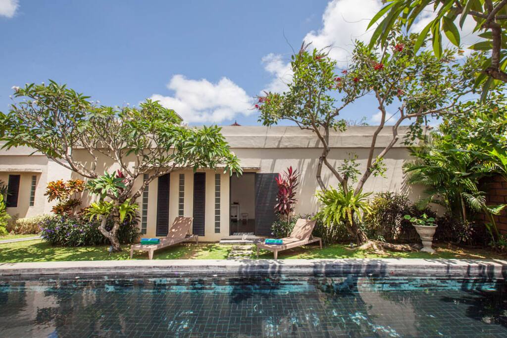 Poolside with daybeds. Get your swim wear on and enjoy tanning!